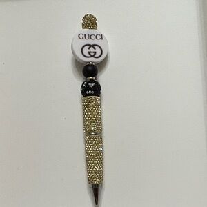 Gold and Black Beaded Writing Instrument